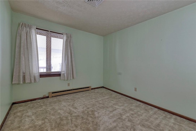 carpeted empty room with a textured ceiling and baseboard heating