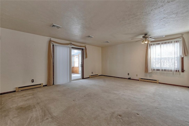 carpeted spare room featuring ceiling fan, a baseboard radiator, and a textured ceiling