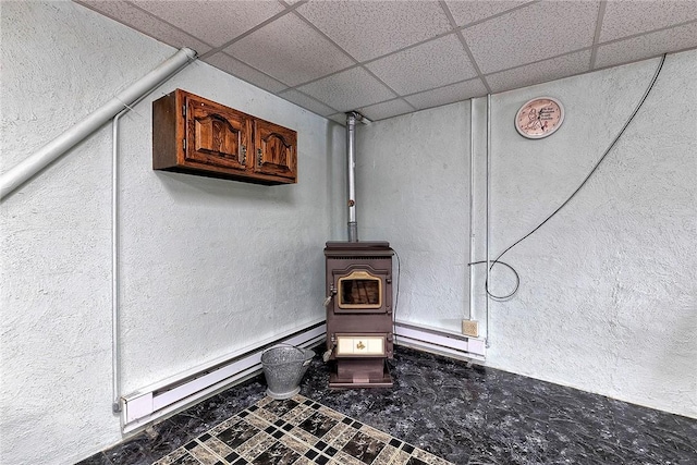 room details with a paneled ceiling and a baseboard radiator