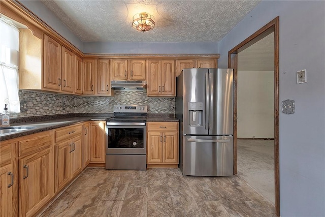 kitchen with decorative backsplash, sink, a textured ceiling, and appliances with stainless steel finishes