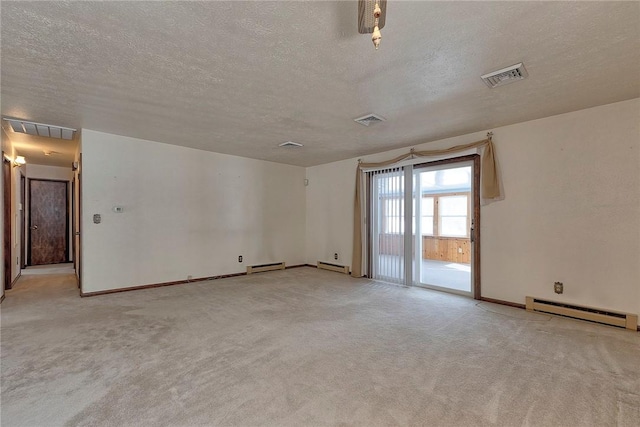 carpeted empty room with a textured ceiling and a baseboard radiator