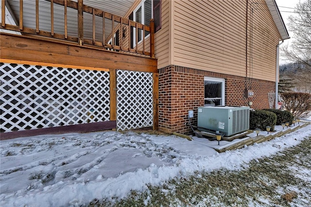 view of snowy exterior with cooling unit