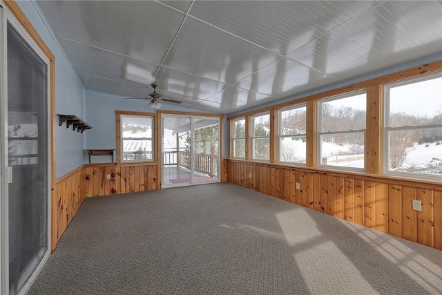 unfurnished sunroom with ceiling fan