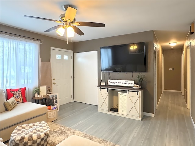 living room with hardwood / wood-style flooring and ceiling fan