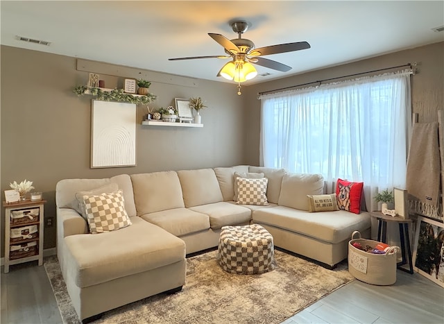 living room featuring hardwood / wood-style floors and ceiling fan