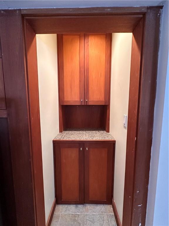 bar featuring light stone countertops