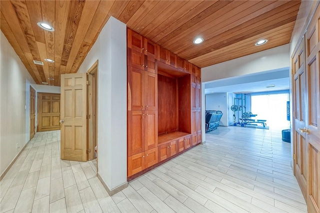 hall with wood ceiling and light hardwood / wood-style flooring