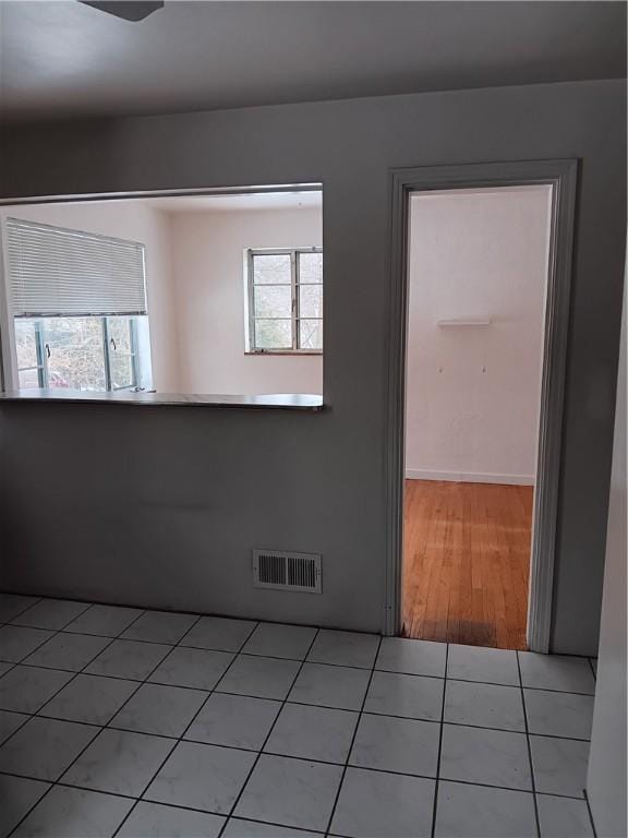 spare room featuring plenty of natural light and light tile patterned flooring