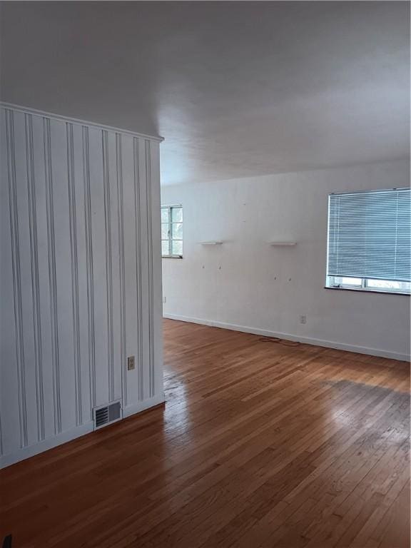 unfurnished room with dark hardwood / wood-style flooring