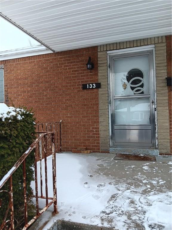 view of snow covered property entrance