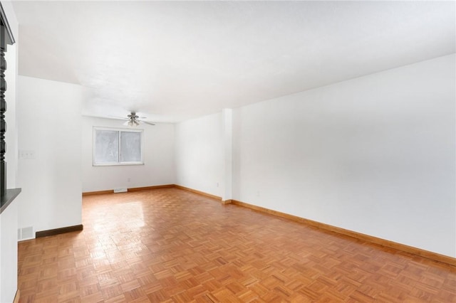 unfurnished room with ceiling fan and light parquet floors