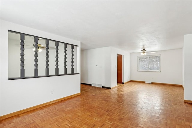 spare room featuring parquet flooring and ceiling fan