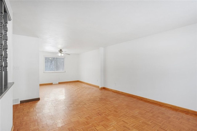 empty room featuring light parquet flooring and ceiling fan