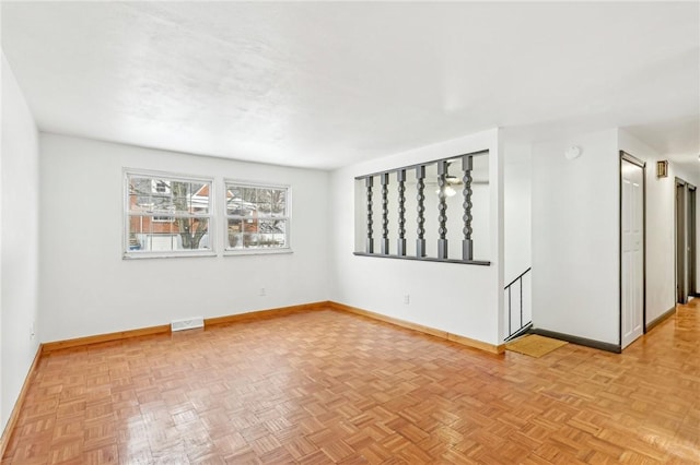 unfurnished room with light parquet flooring