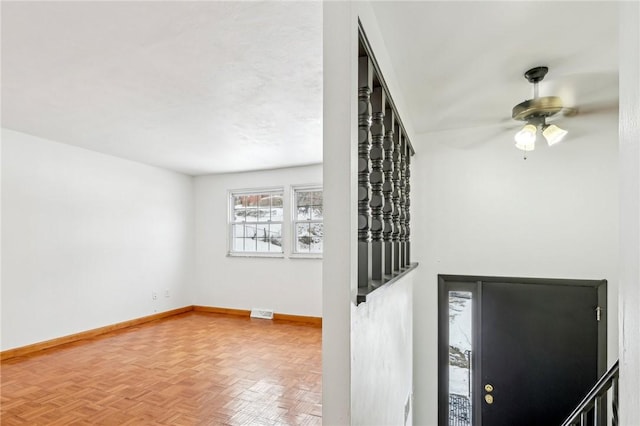 entryway featuring ceiling fan and parquet flooring