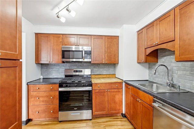 kitchen with stainless steel appliances, tasteful backsplash, and sink