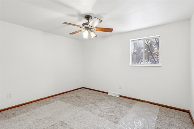 spare room with carpet flooring and ceiling fan