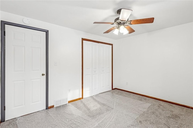 unfurnished bedroom featuring carpet, ceiling fan, and a closet