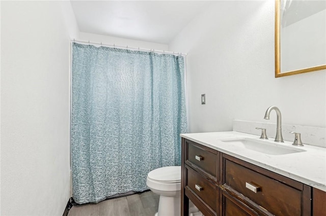 bathroom featuring hardwood / wood-style flooring, vanity, and toilet