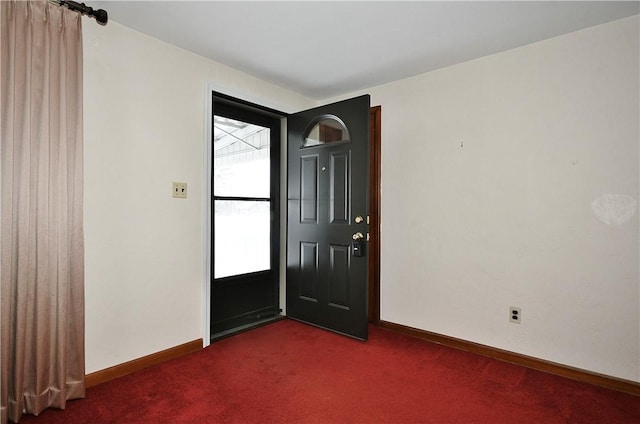 entryway with dark carpet