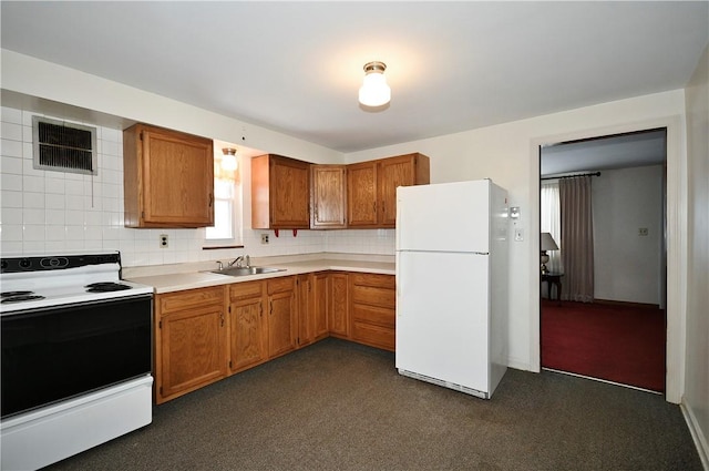 kitchen with sink, backsplash, range with electric cooktop, and white fridge