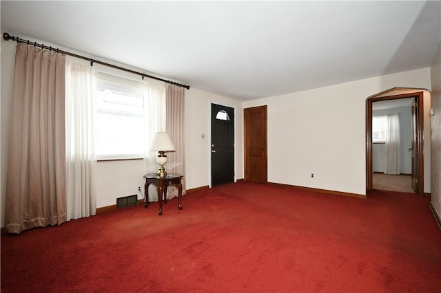 spare room featuring dark colored carpet