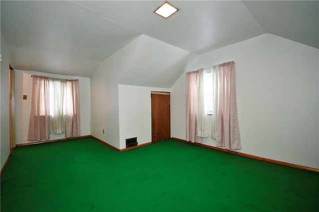 additional living space featuring lofted ceiling, carpet floors, and plenty of natural light