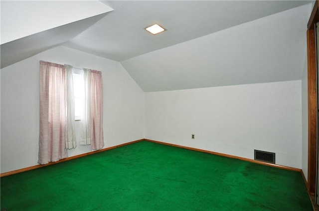 bonus room with lofted ceiling and carpet floors