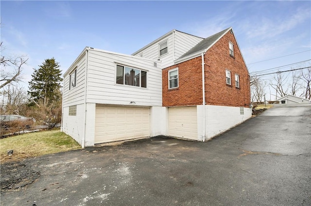 view of side of home featuring a garage