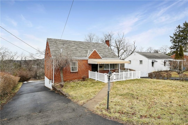 bungalow-style house with a front lawn and covered porch