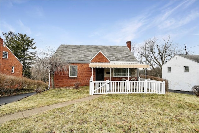 bungalow-style home featuring a front yard and covered porch