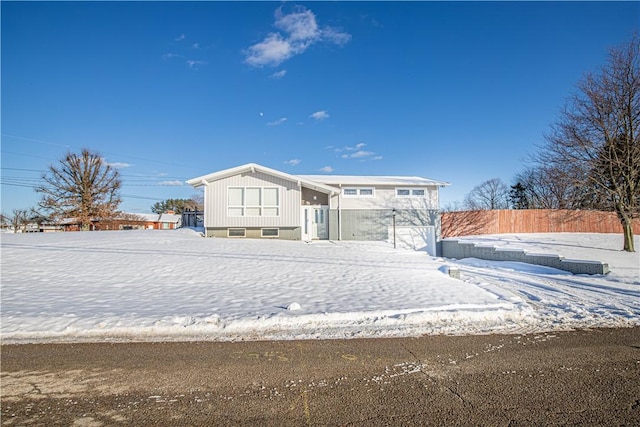 view of snow covered back of property