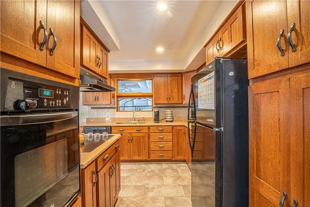 kitchen featuring backsplash, sink, and black appliances