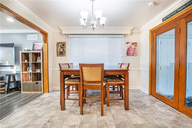 dining space featuring ornamental molding and a notable chandelier