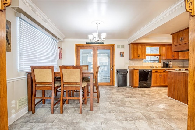 dining area featuring ornamental molding and an inviting chandelier