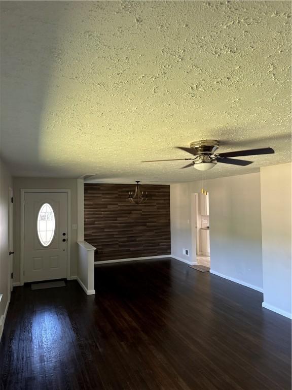 entrance foyer featuring a textured ceiling, dark hardwood / wood-style flooring, and ceiling fan