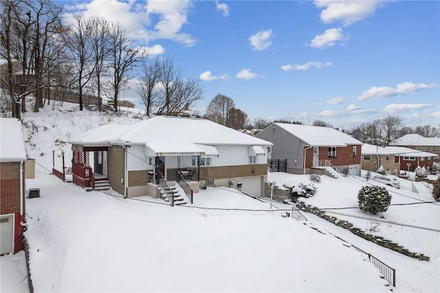 view of snow covered back of property