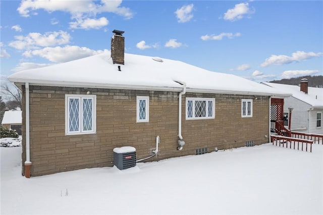 view of snow covered rear of property