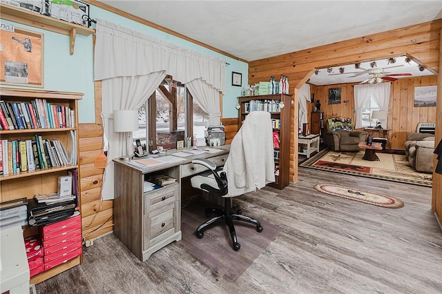 office with ceiling fan, wood walls, wood-type flooring, and plenty of natural light