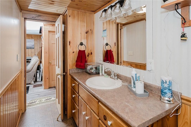 bathroom with vanity, wood ceiling, and wooden walls