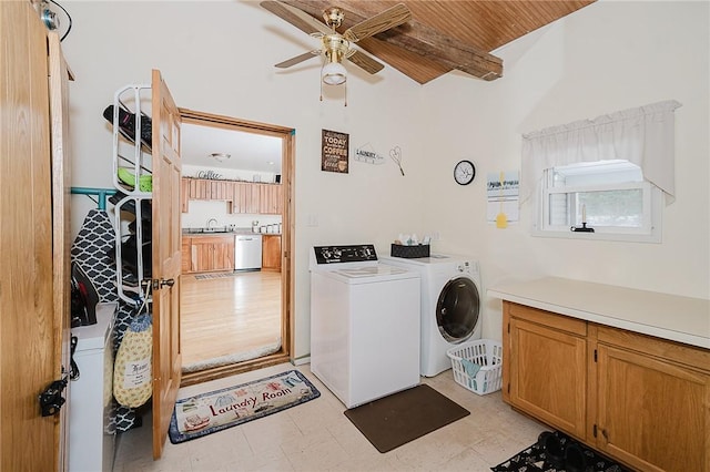 washroom with cabinets, sink, ceiling fan, washing machine and dryer, and wood ceiling