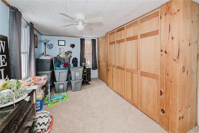 misc room featuring light colored carpet and ceiling fan