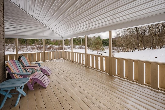 unfurnished sunroom featuring vaulted ceiling