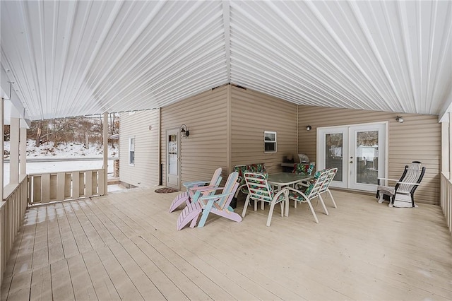 snow covered deck featuring french doors