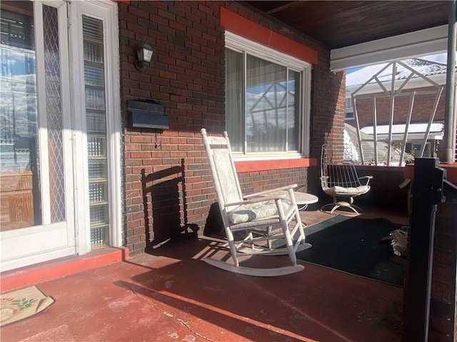 exterior space with a porch and glass enclosure