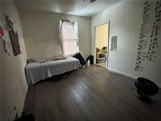 bedroom with wood-type flooring and a textured ceiling