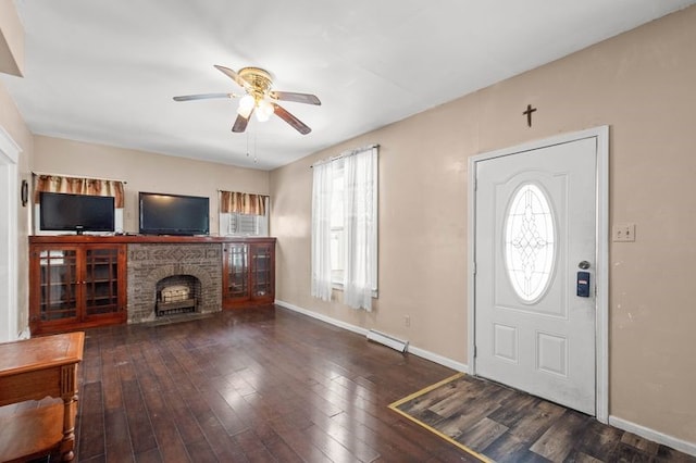 foyer with a wealth of natural light, hardwood / wood-style floors, a fireplace, and ceiling fan