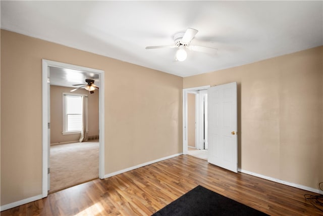 unfurnished bedroom with baseboards, wood finished floors, and a ceiling fan