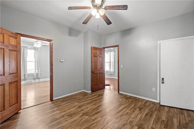 unfurnished bedroom with baseboards, light wood-style floors, and ceiling fan