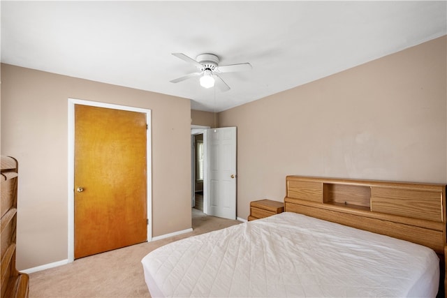 bedroom with a ceiling fan, baseboards, and carpet floors